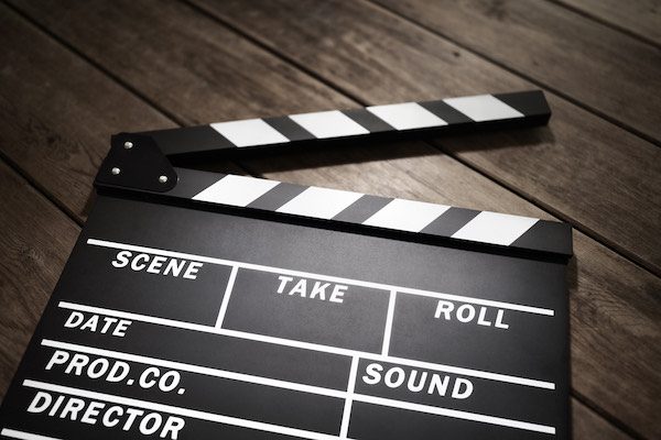 Film slate or movie clapper board on wood background